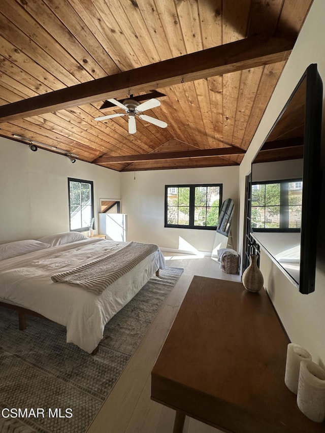 bedroom with multiple windows, vaulted ceiling with beams, wood ceiling, and ceiling fan