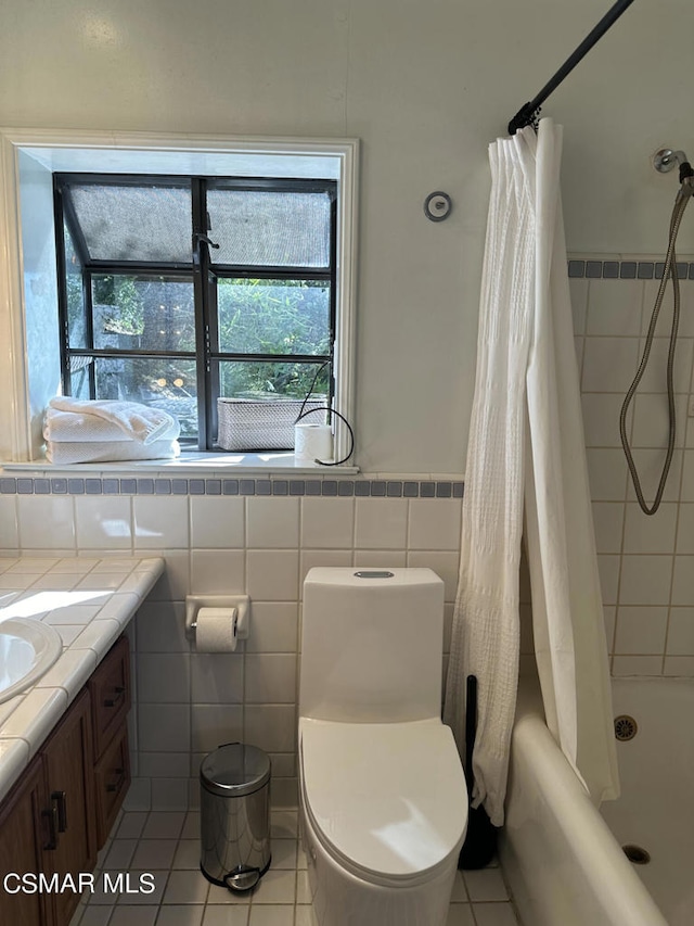 full bathroom featuring tile patterned flooring, vanity, toilet, and shower / bath combination with curtain