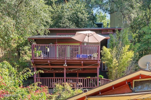 back of house featuring a balcony