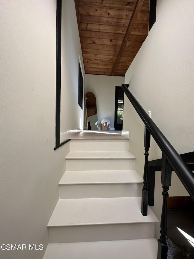 staircase with wood ceiling and vaulted ceiling