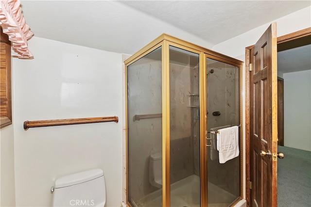 bathroom featuring a textured ceiling, walk in shower, and toilet