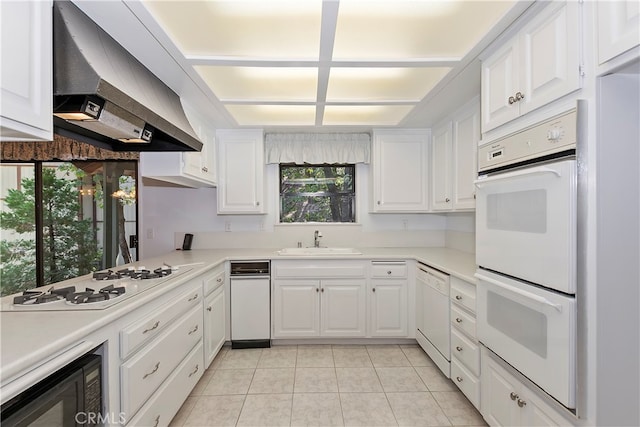 kitchen with wall chimney exhaust hood, white cabinets, white appliances, and sink