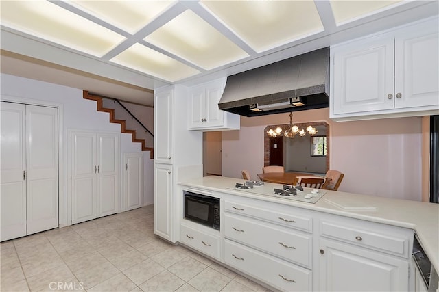 kitchen featuring hanging light fixtures, white cabinetry, white gas cooktop, black microwave, and range hood