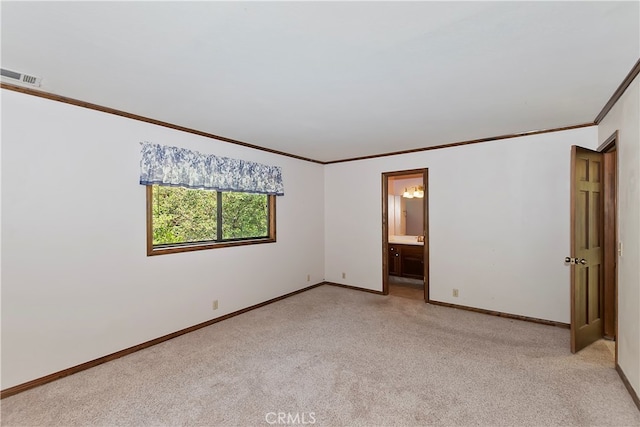 unfurnished room with light colored carpet and crown molding