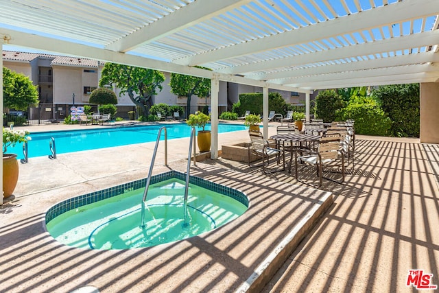 view of pool with a pergola, a community hot tub, and a patio