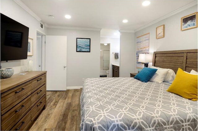 bedroom featuring connected bathroom, crown molding, and light hardwood / wood-style floors