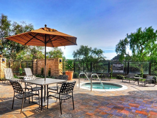 view of swimming pool with a patio and a hot tub