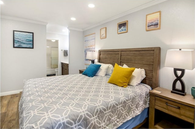 bedroom featuring hardwood / wood-style flooring, ornamental molding, and ensuite bath