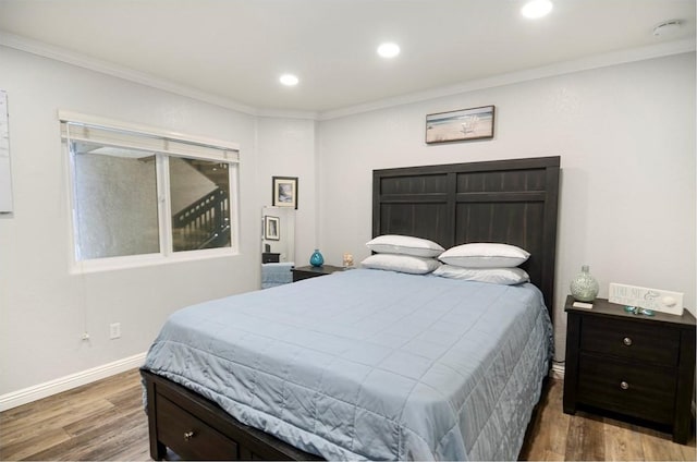 bedroom with dark hardwood / wood-style flooring and ornamental molding