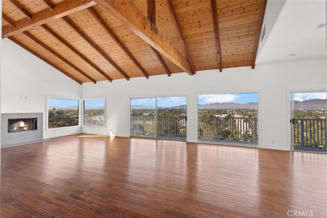 unfurnished living room featuring wooden ceiling, hardwood / wood-style flooring, beamed ceiling, and high vaulted ceiling