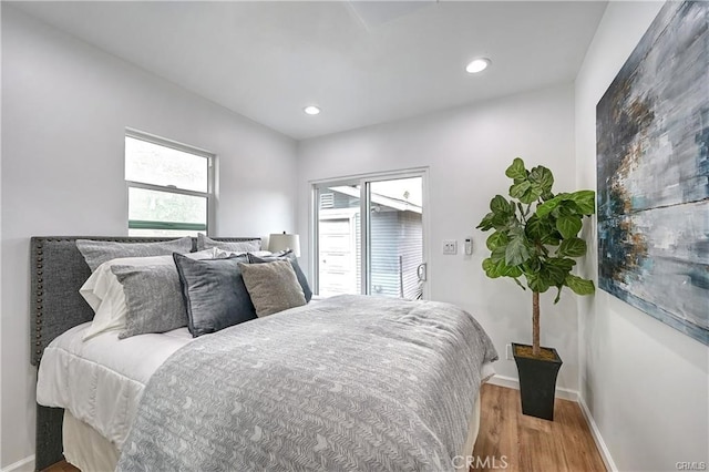 bedroom featuring wood-type flooring and access to exterior