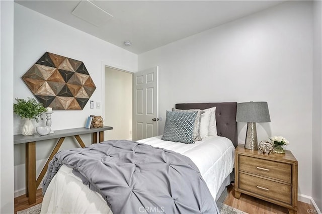 bedroom with hardwood / wood-style floors