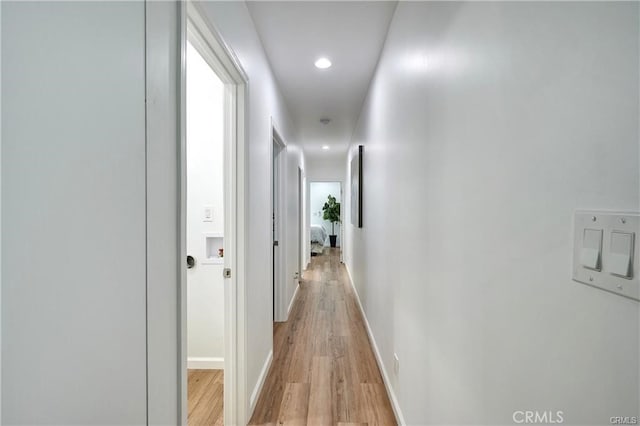 hall with light hardwood / wood-style floors