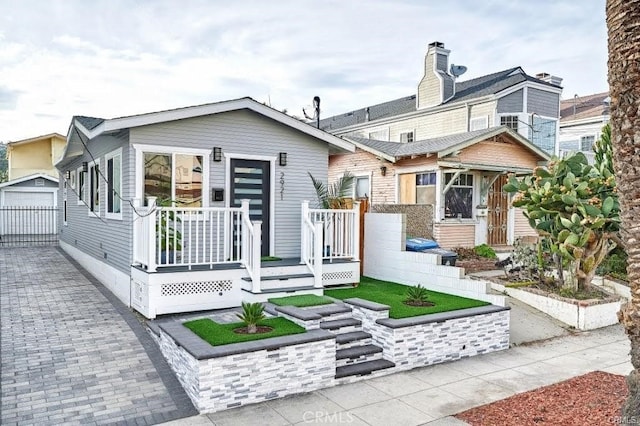 rear view of property featuring an outbuilding and a garage