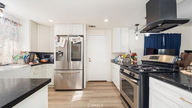 kitchen with visible vents, appliances with stainless steel finishes, light wood-style floors, island range hood, and white cabinetry