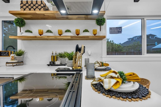 interior space with range hood and backsplash