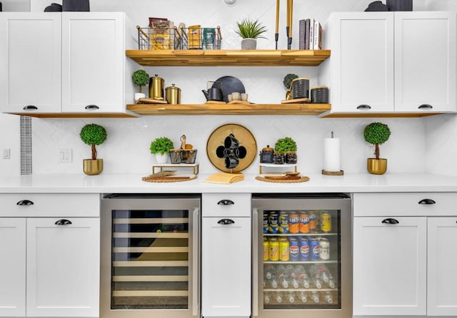 bar with beverage cooler and white cabinetry