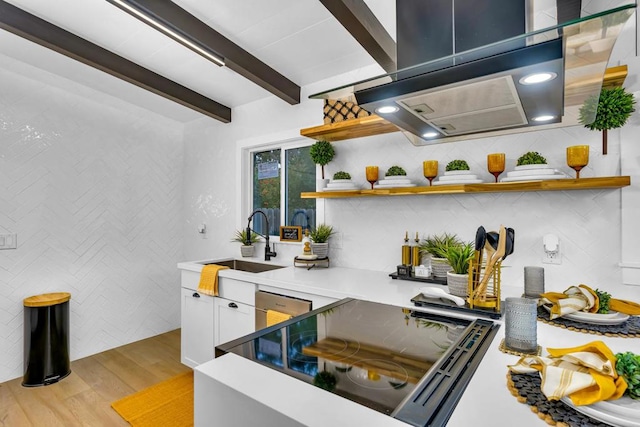 kitchen featuring dishwasher, white cabinetry, beamed ceiling, sink, and light hardwood / wood-style flooring