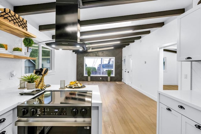 kitchen with white cabinets, island exhaust hood, a healthy amount of sunlight, electric stove, and light wood-type flooring