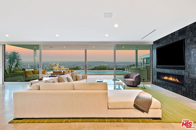 living room with a fireplace and floor to ceiling windows