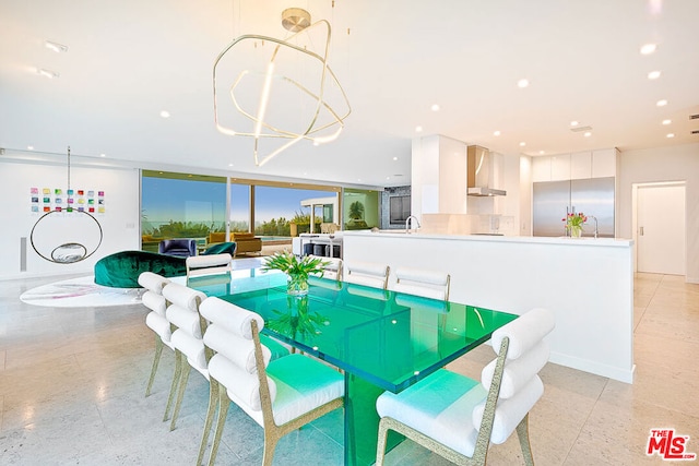 dining space with an inviting chandelier, floor to ceiling windows, and sink