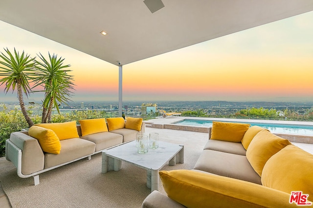 patio terrace at dusk featuring outdoor lounge area