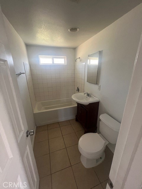 full bathroom with tile patterned flooring, vanity, toilet, and tiled shower / bath