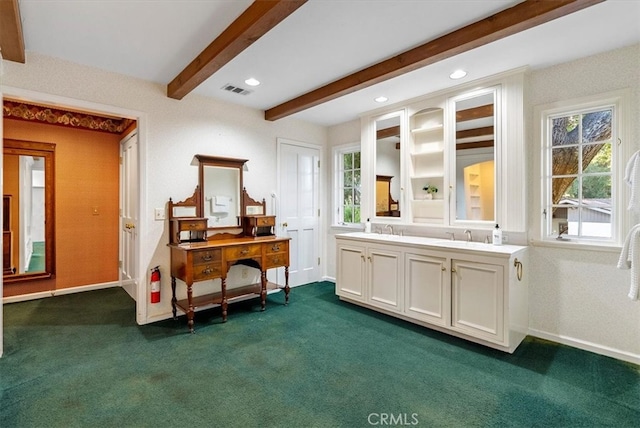 misc room with beamed ceiling, sink, and dark carpet