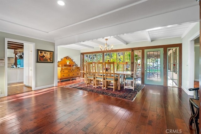 dining room with beam ceiling, a chandelier, and dark hardwood / wood-style floors