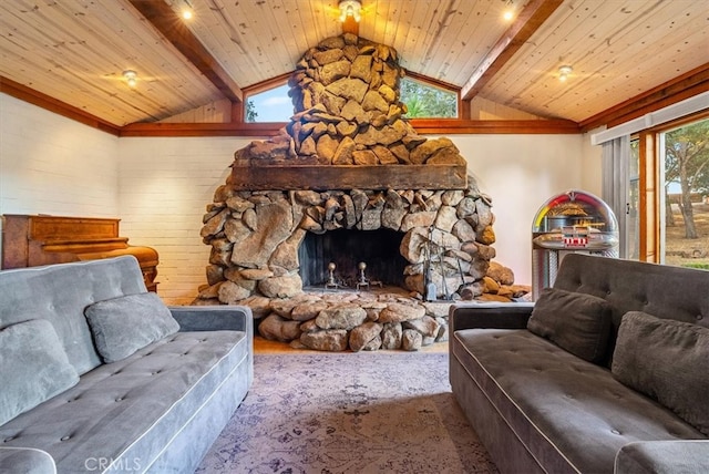 living room featuring wood ceiling, a stone fireplace, and vaulted ceiling with beams