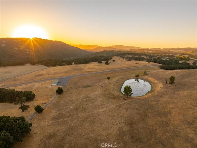 aerial view at dusk featuring a mountain view