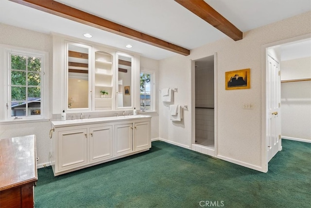 bathroom featuring vanity, beam ceiling, and walk in shower