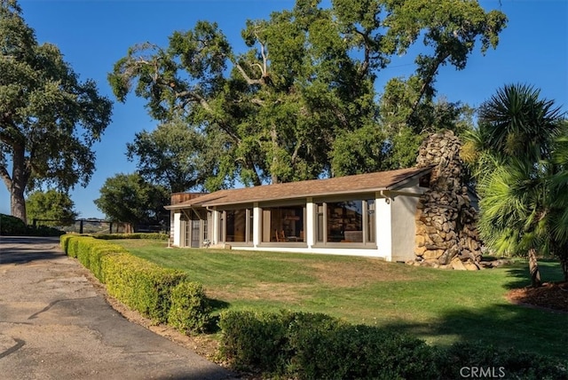 view of property exterior with a lawn