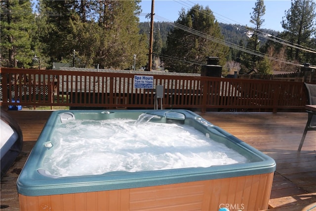 wooden deck featuring an outdoor hot tub