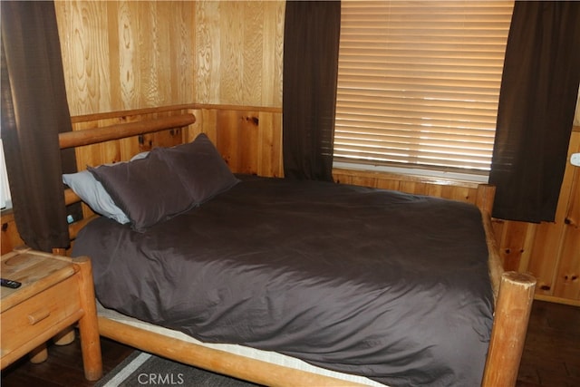 bedroom with wooden walls