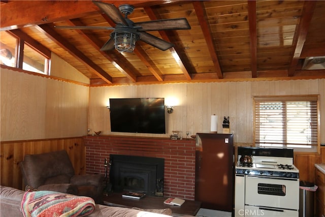 living room with lofted ceiling with beams, wood walls, ceiling fan, and wooden ceiling