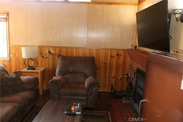 living room featuring a fireplace and wood walls