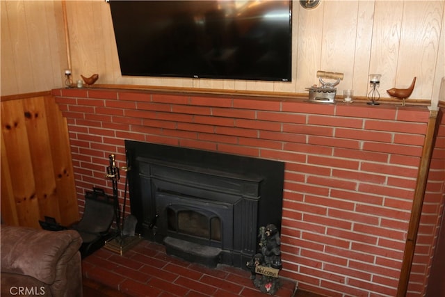 details featuring a fireplace and wood walls