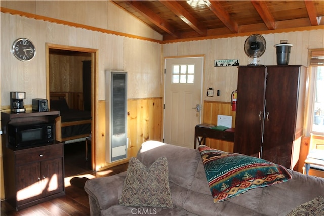 living room with wooden ceiling, vaulted ceiling with beams, wood-type flooring, and plenty of natural light