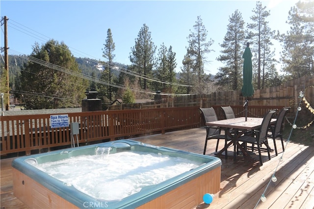 wooden terrace featuring an outdoor hot tub