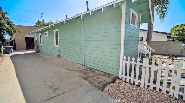 view of property exterior with a patio area