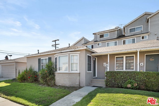 view of front facade with a front yard and a garage