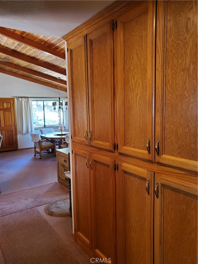 corridor with carpet, wood ceiling, vaulted ceiling with beams, and an inviting chandelier