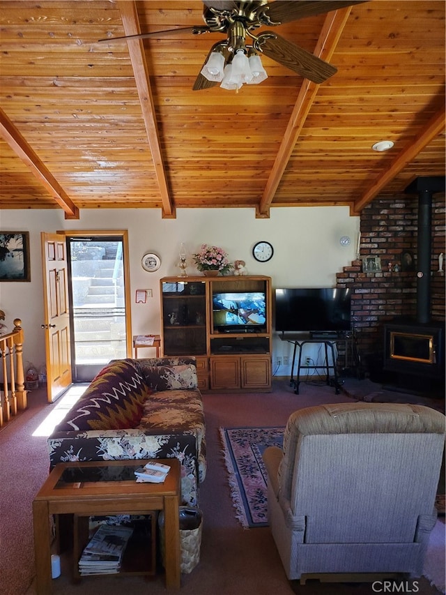 carpeted living room with wood ceiling, ceiling fan, beamed ceiling, and a wood stove