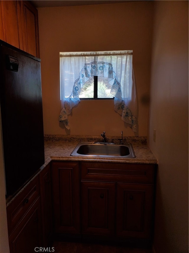 kitchen with black fridge and sink