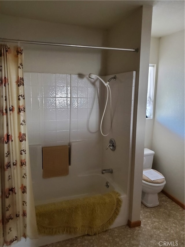 bathroom featuring toilet and shower / bath combo