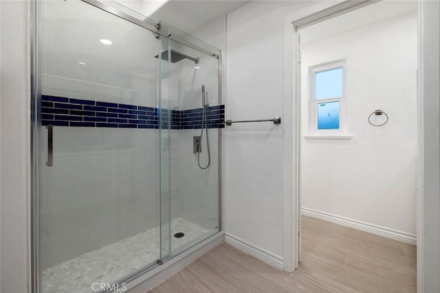 16592 Grimaud Ln, Huntington Beach, CA 92649 - bathroom with baseboards, a stall shower, and wood finished floors