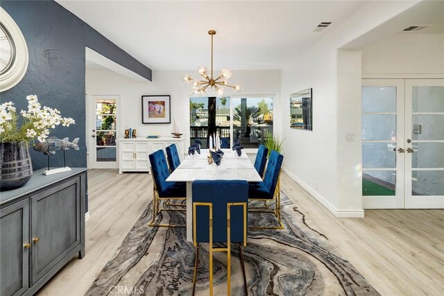 16592 Grimaud Ln, Huntington Beach, CA 92649 - dining area with french doors, light wood-style flooring, and a chandelier