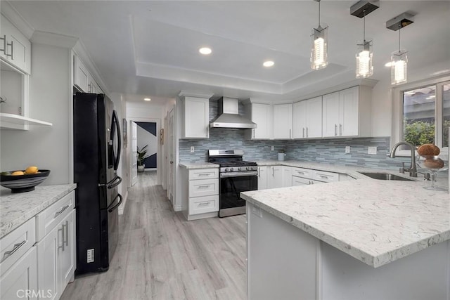 16592 Grimaud Ln, Huntington Beach, CA 92649 - kitchen with stainless steel gas range, wall chimney range hood, black fridge, a sink, and a raised ceiling
