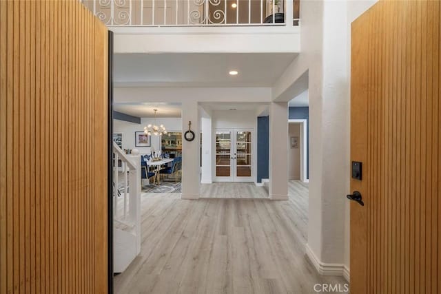 16592 Grimaud Ln, Huntington Beach, CA 92649 - entrance foyer with wood finished floors, french doors, a chandelier, and baseboards